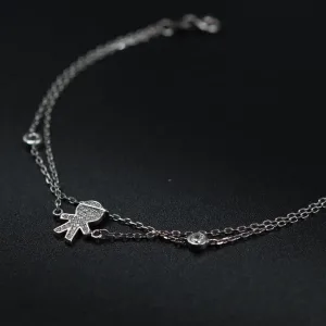 Srebrna dupla narukvica sa priveskom decaka